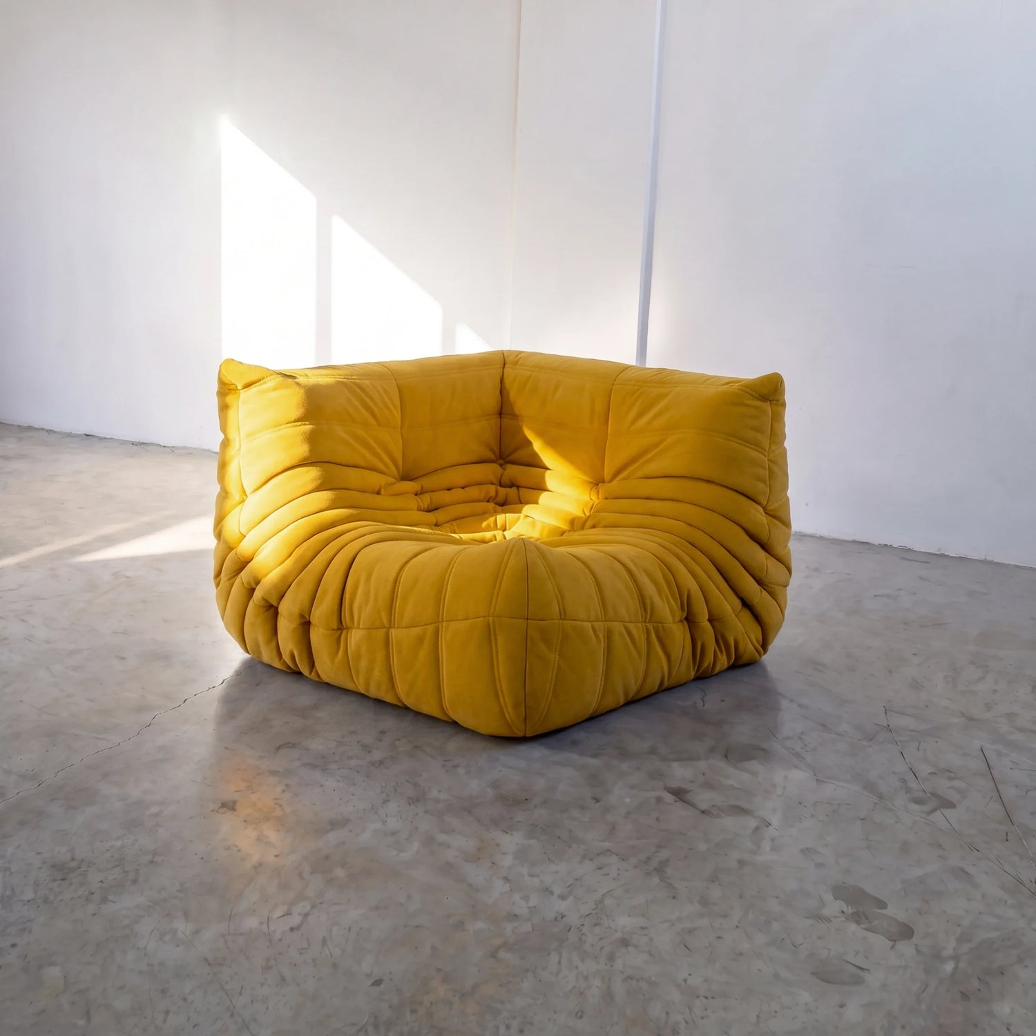togo sofa dupe corner module in yellow velvet shown from the front in a sunlit studio by vibehaus