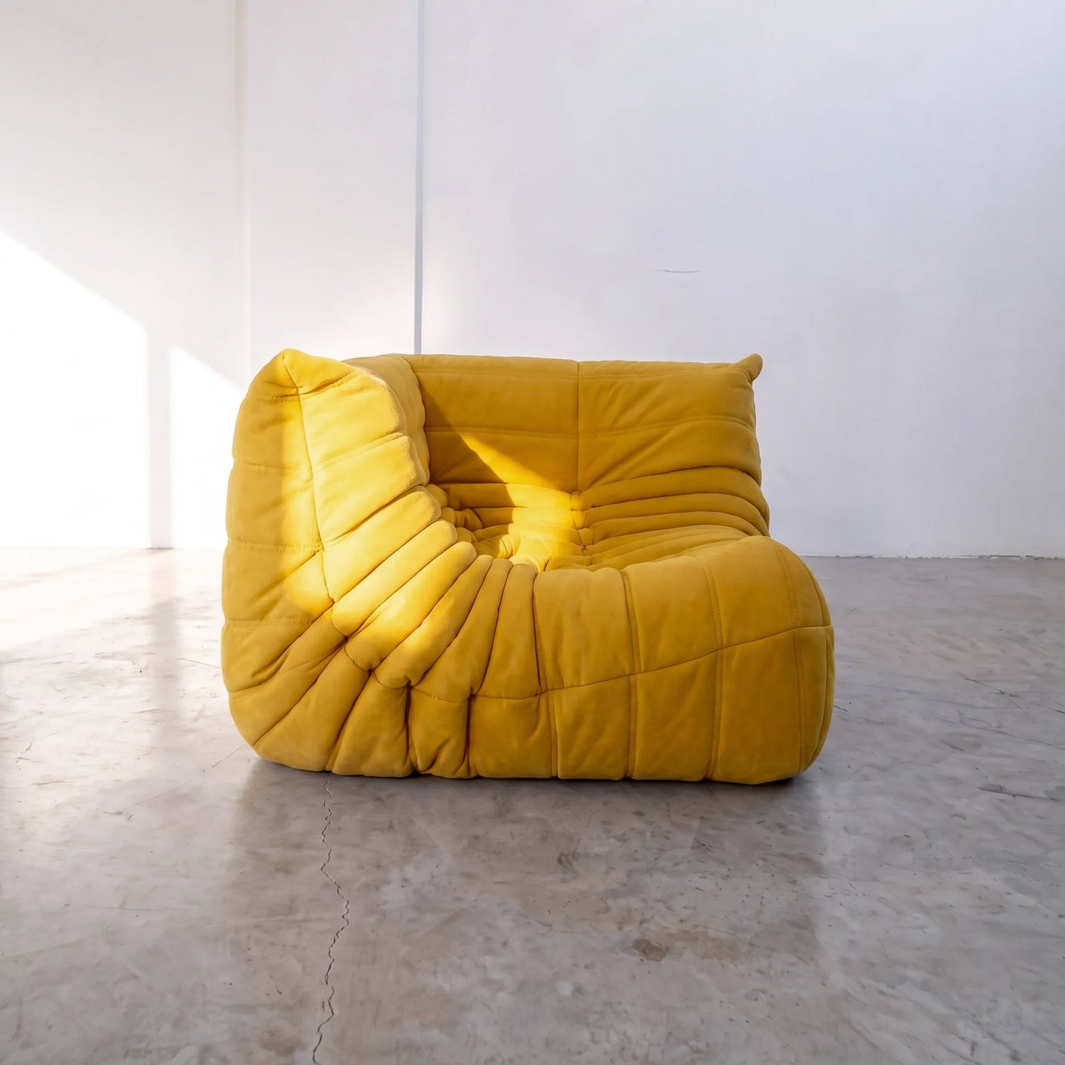 togo sofa dupe corner module in yellow velvet shown from an angled side view by vibehaus