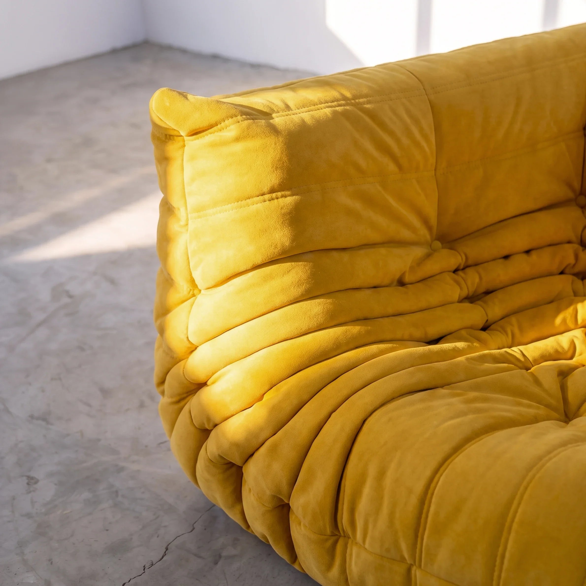 togo sofa dupe corner module close-up showing the yellow velvet upholstery and tufting by vibehaus