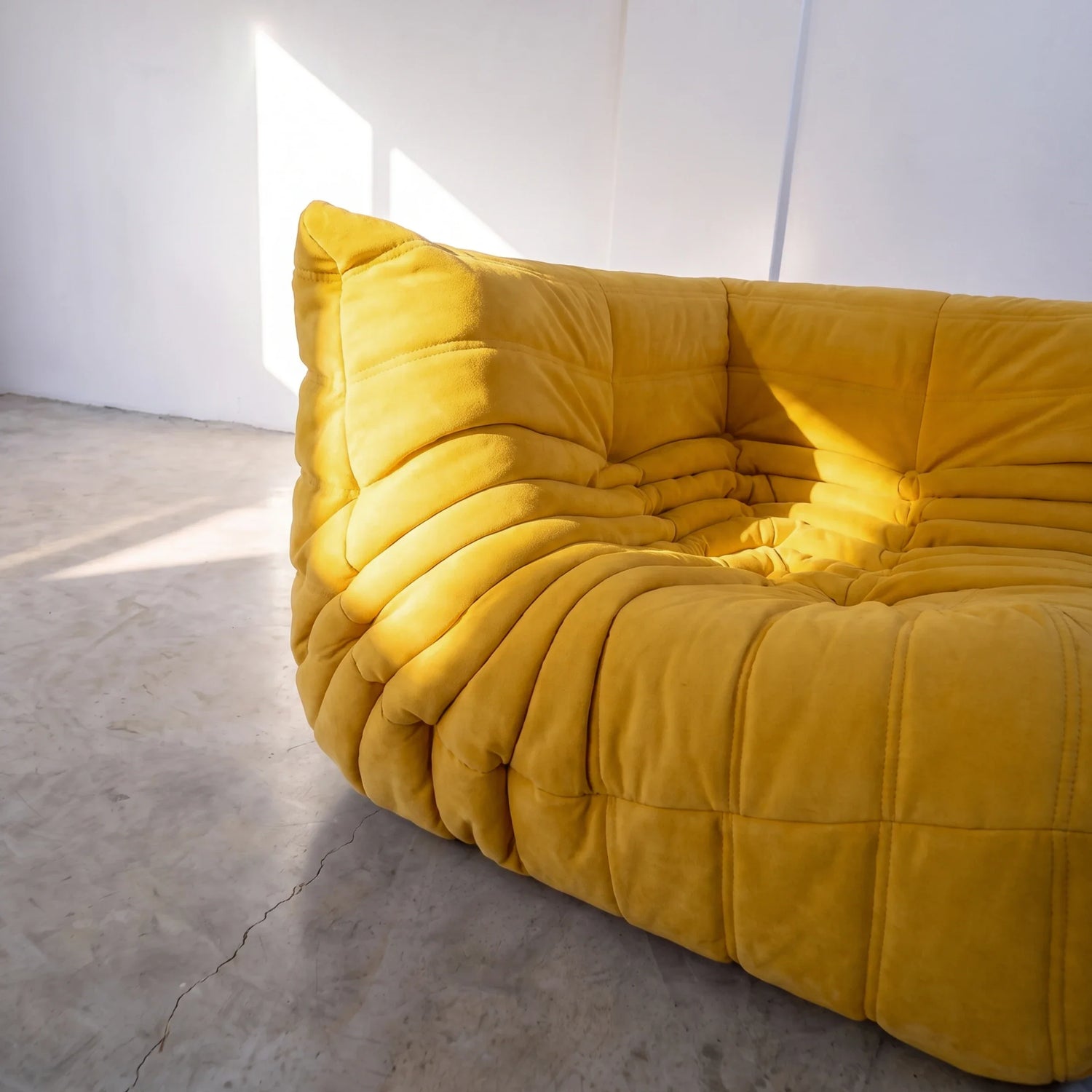 togo sofa dupe corner module in yellow velvet shown in a detailed side view by vibehaus