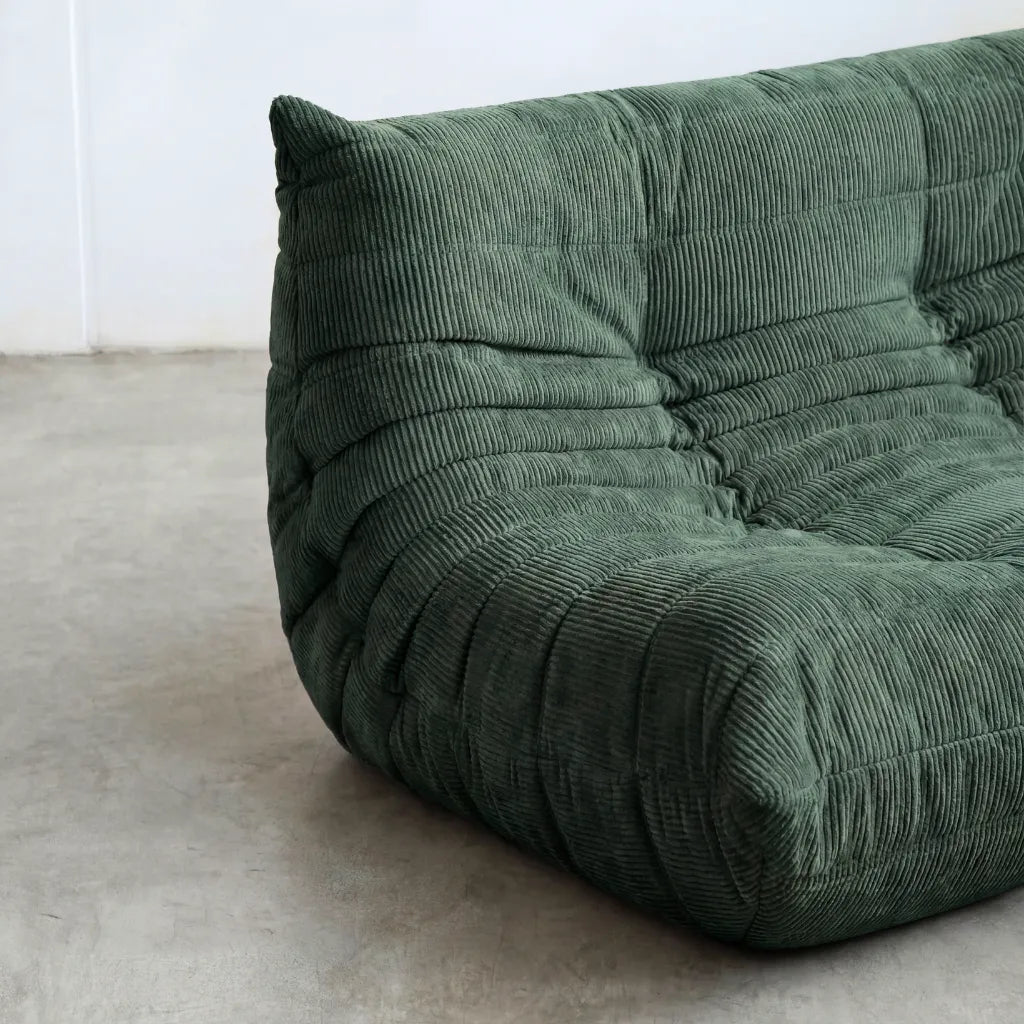 Close up of the Togo 2-seater Sofa dupe in dark green corduroy with Togo silhouette designed by michael ducaroy for ligne roset – custom-made by vibehaus