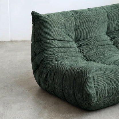 Close up of the Togo 2-seater Sofa dupe in dark green corduroy with Togo silhouette designed by michael ducaroy for ligne roset – custom-made by vibehaus