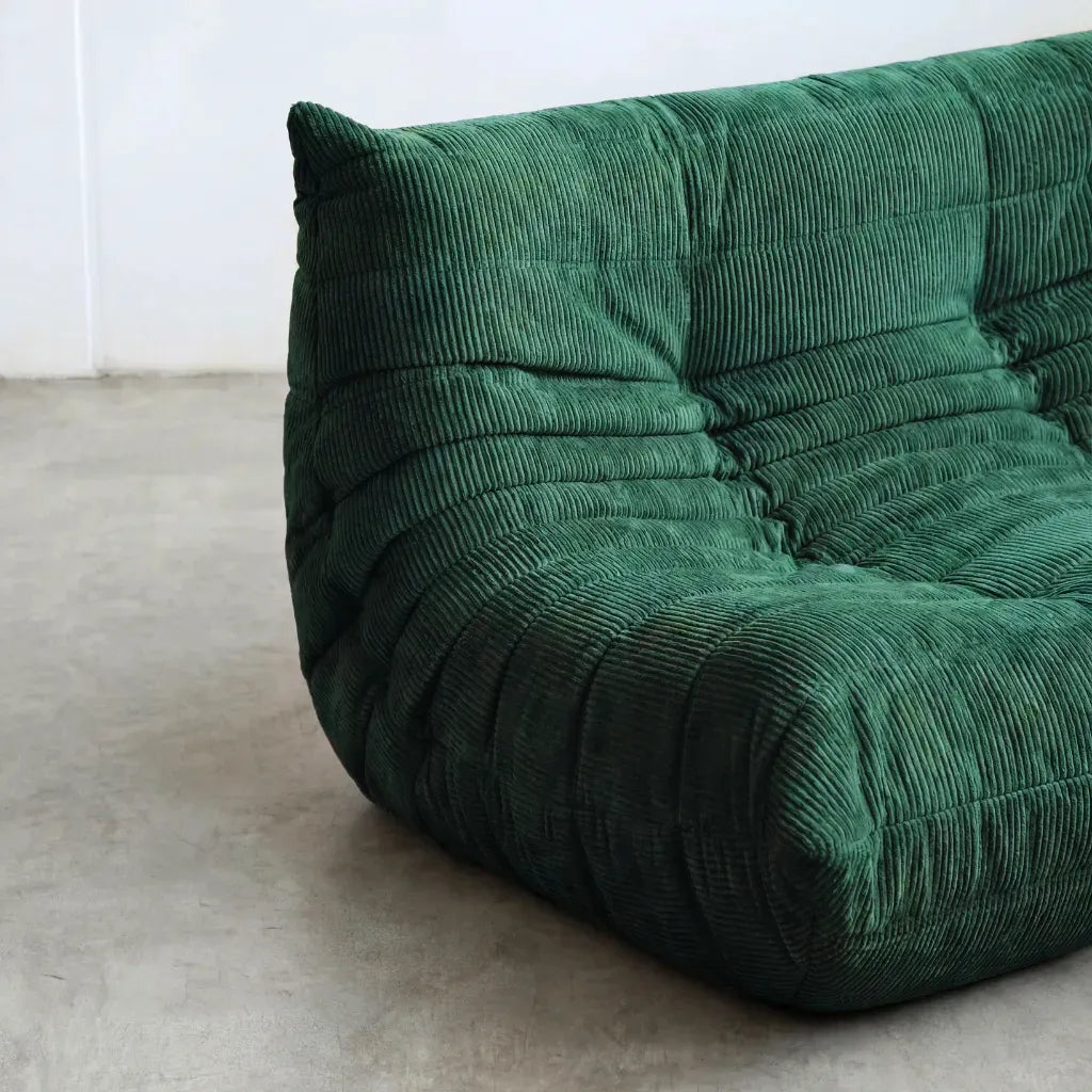 Close up of the Togo 2-seater Sofa dupe in dark green corduroy with Togo silhouette designed by michael ducaroy for ligne roset – custom-made by vibehaus