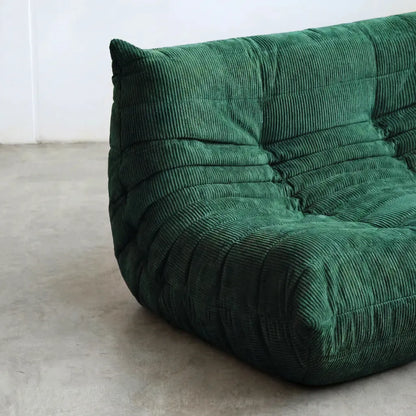 Close up of the Togo 2-seater Sofa dupe in dark green corduroy with Togo silhouette designed by michael ducaroy for ligne roset – custom-made by vibehaus