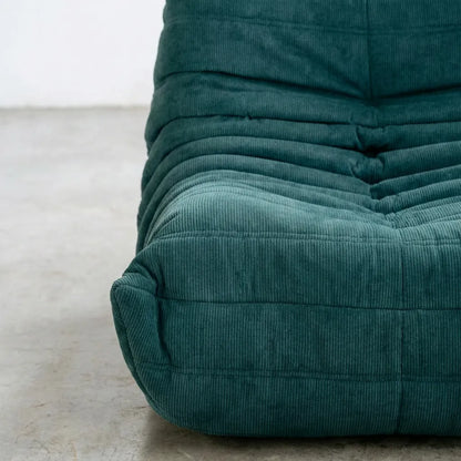 Close up of the Togo 2-seater Sofa replica in turquoise blue corduroy with Togo silhouette designed by michael ducaroy for ligne roset – custom-made by vibehaus