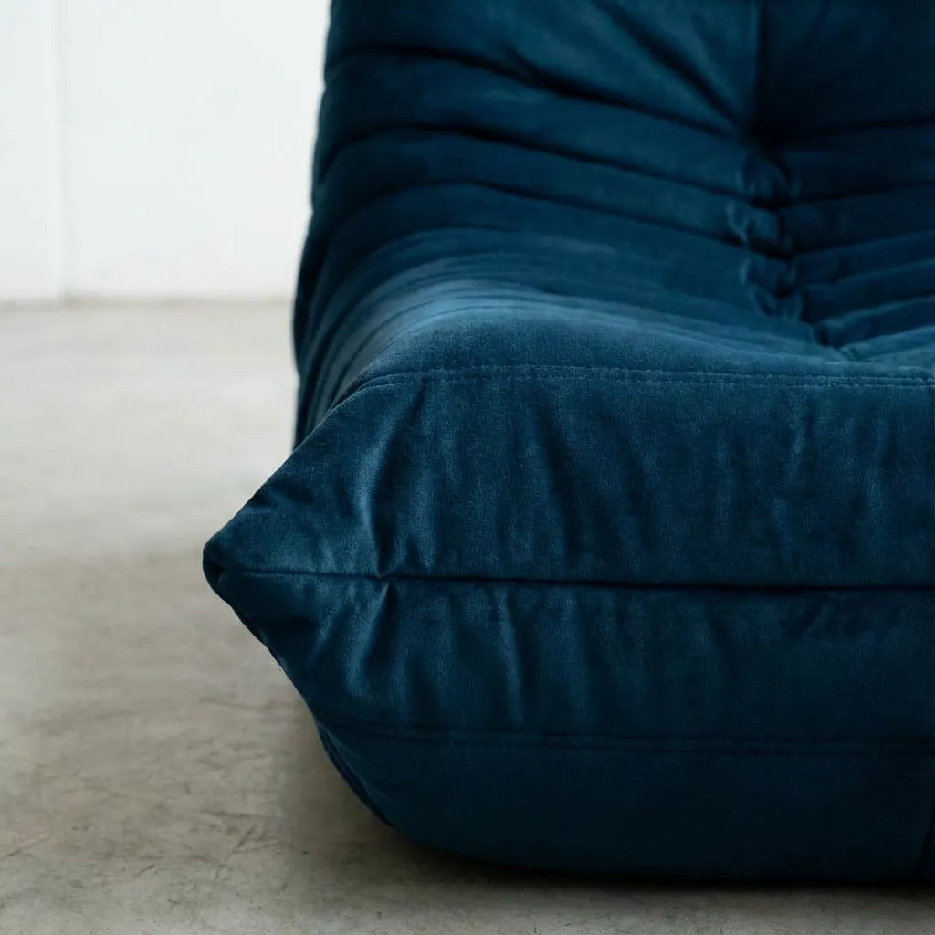 Close up of the Togo 2-seater Sofa replica in dark blue velvet suede with Togo silhouette designed by michael ducaroy for ligne roset – custom-made by vibehaus
