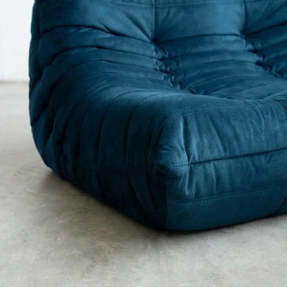 Close up of the Togo 2-seater Sofa dupe in dark blue velvet suede with Togo silhouette designed by michael ducaroy for ligne roset – custom-made by vibehaus