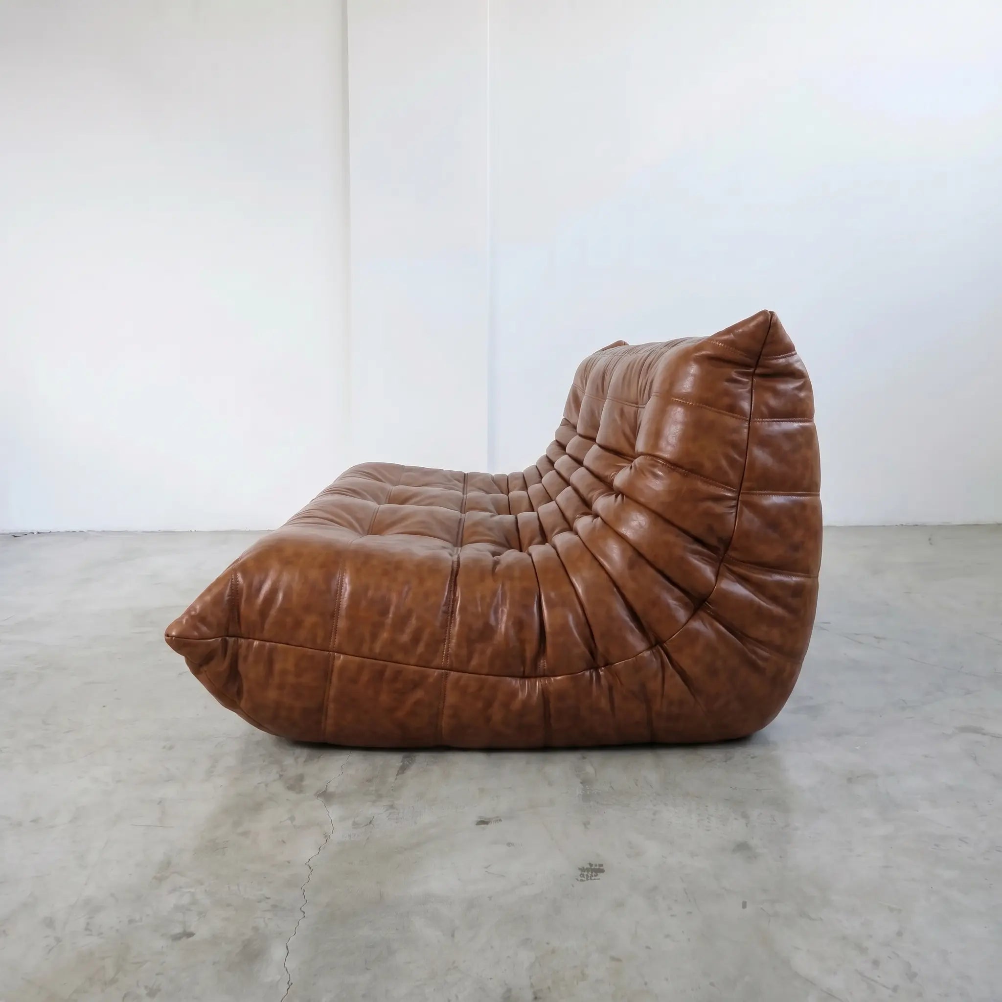 Brown leather togo sofa 3-seater dupe on a beige background