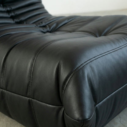 Close up of the Togo Chair dupe in black faux leather by vibehaus