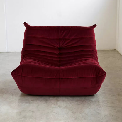 Replica of the burgundy velvet Togo-chair by michael ducaroy–  low, frameless design with plush channel tufting