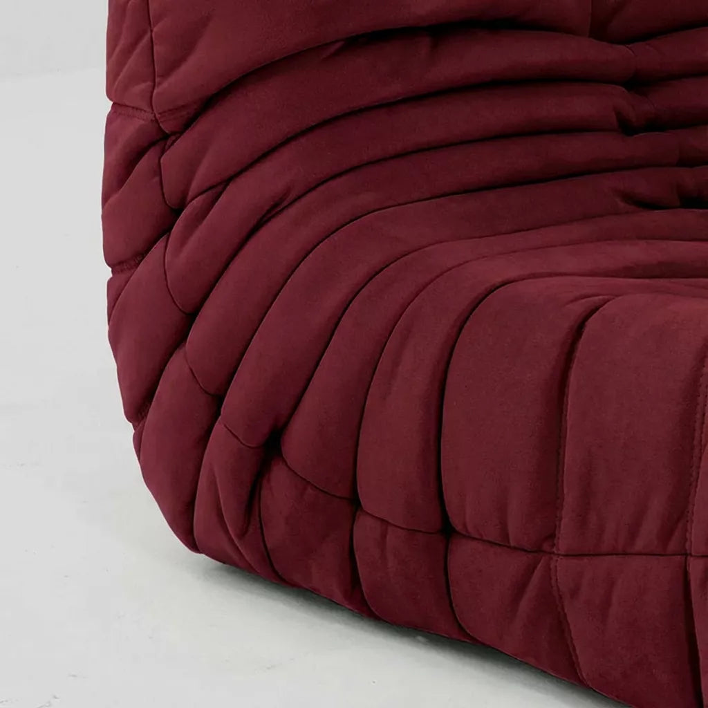 Close-up of the dupe burgundy velvet suede upholstery togo fireside chair lounger – soft, dirt-resistant fabric with luxurious texture