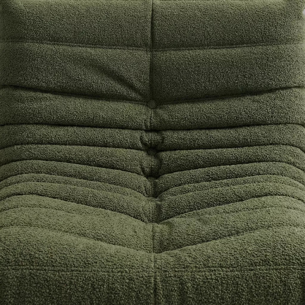 Replica of the green boucle Togo-chair by michael ducaroy–  low, frameless design with plush channel tufting