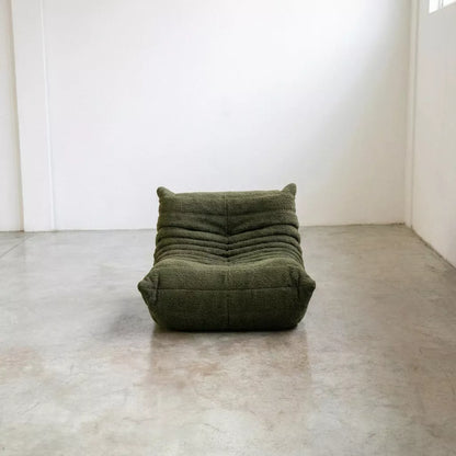 Replica of the green boucle Togo-chair by michael ducaroy–  low, frameless design with plush channel tufting
