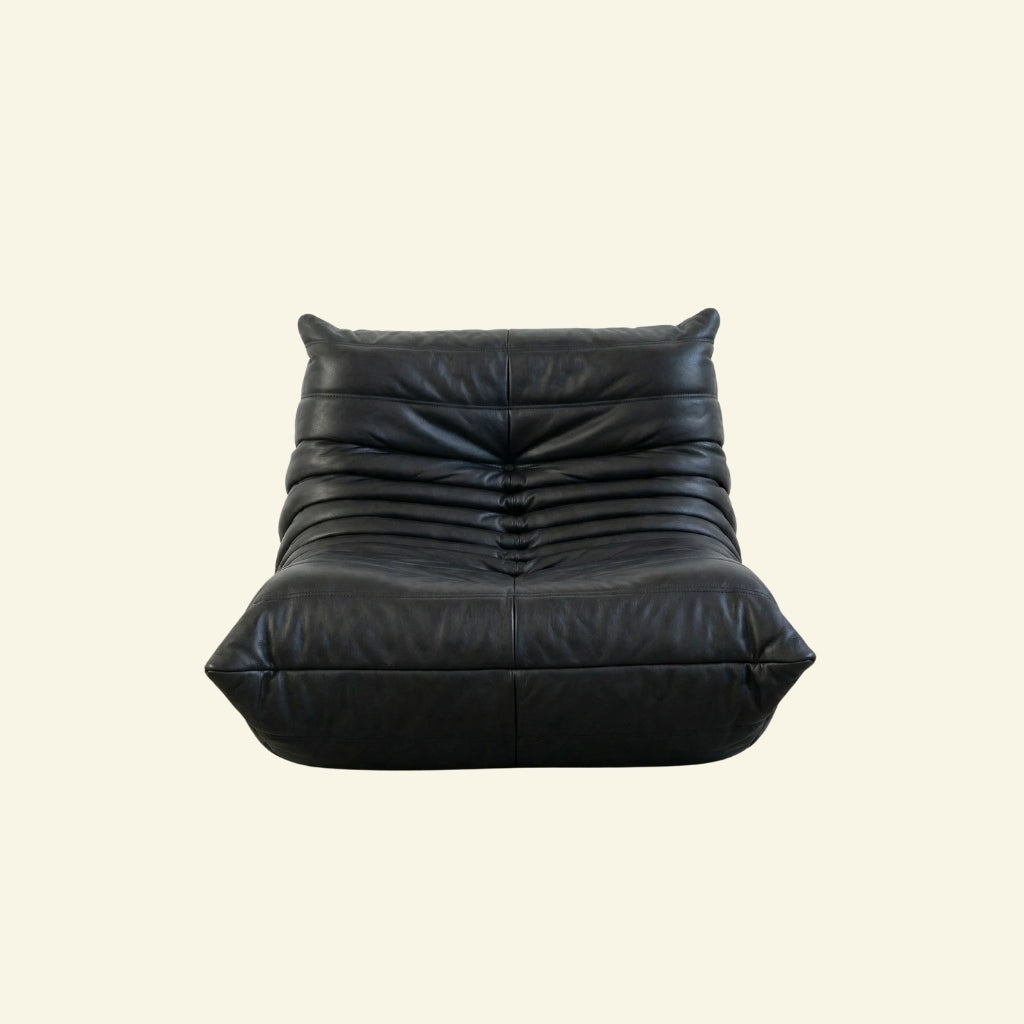 Togo Chair Dupe in black faux leather on a beige background by vibehaus