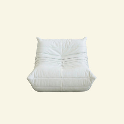 Togo Chair Dupe in white faux leather on a beige background by vibehaus