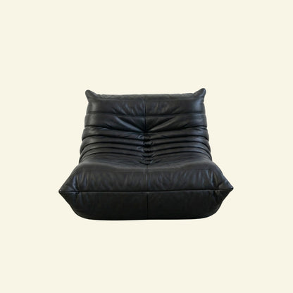Togo Chair Dupe in black real cowhide leather on a beige background by vibehaus