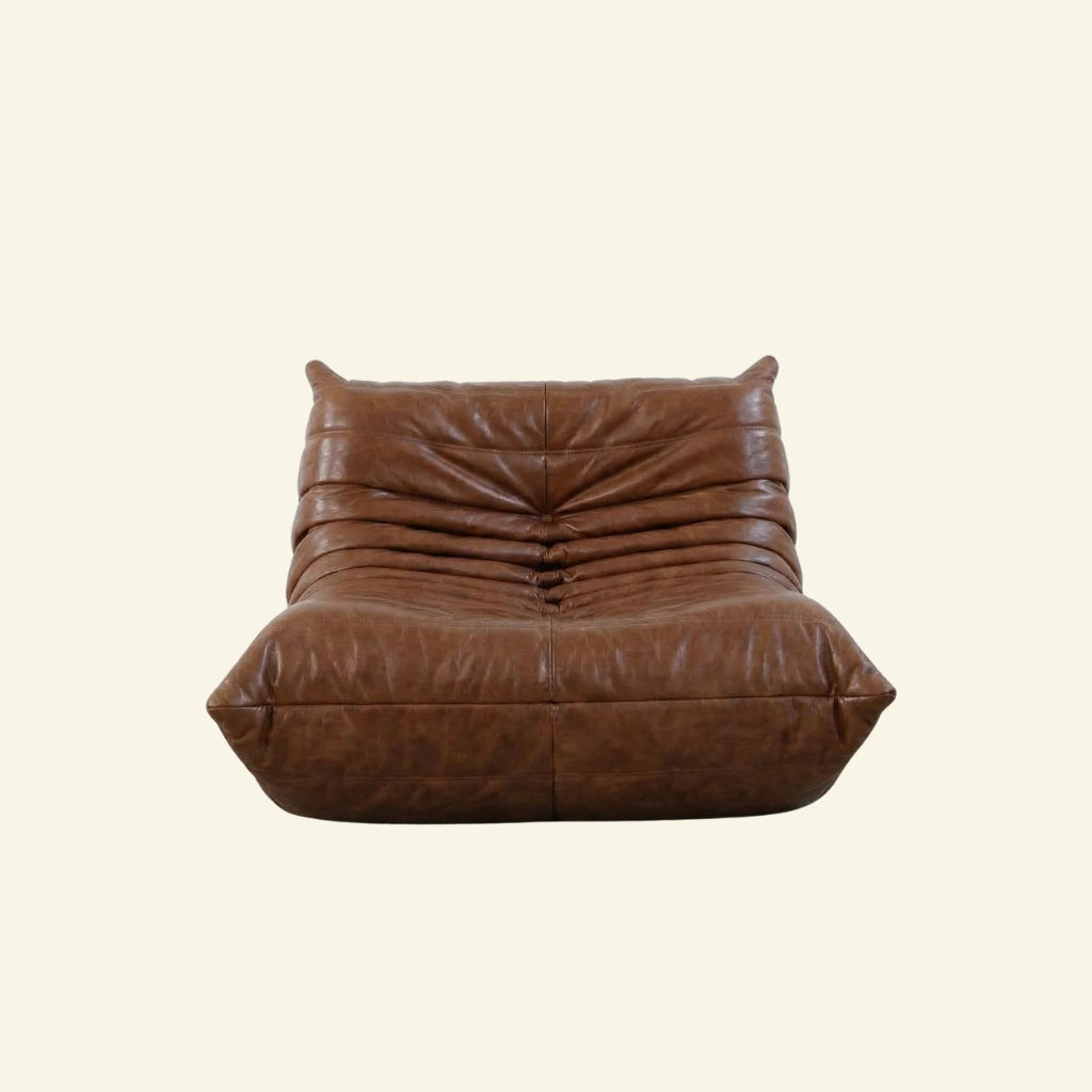 Togo Chair Dupe in brown real oil wax leather on a beige background by vibehaus