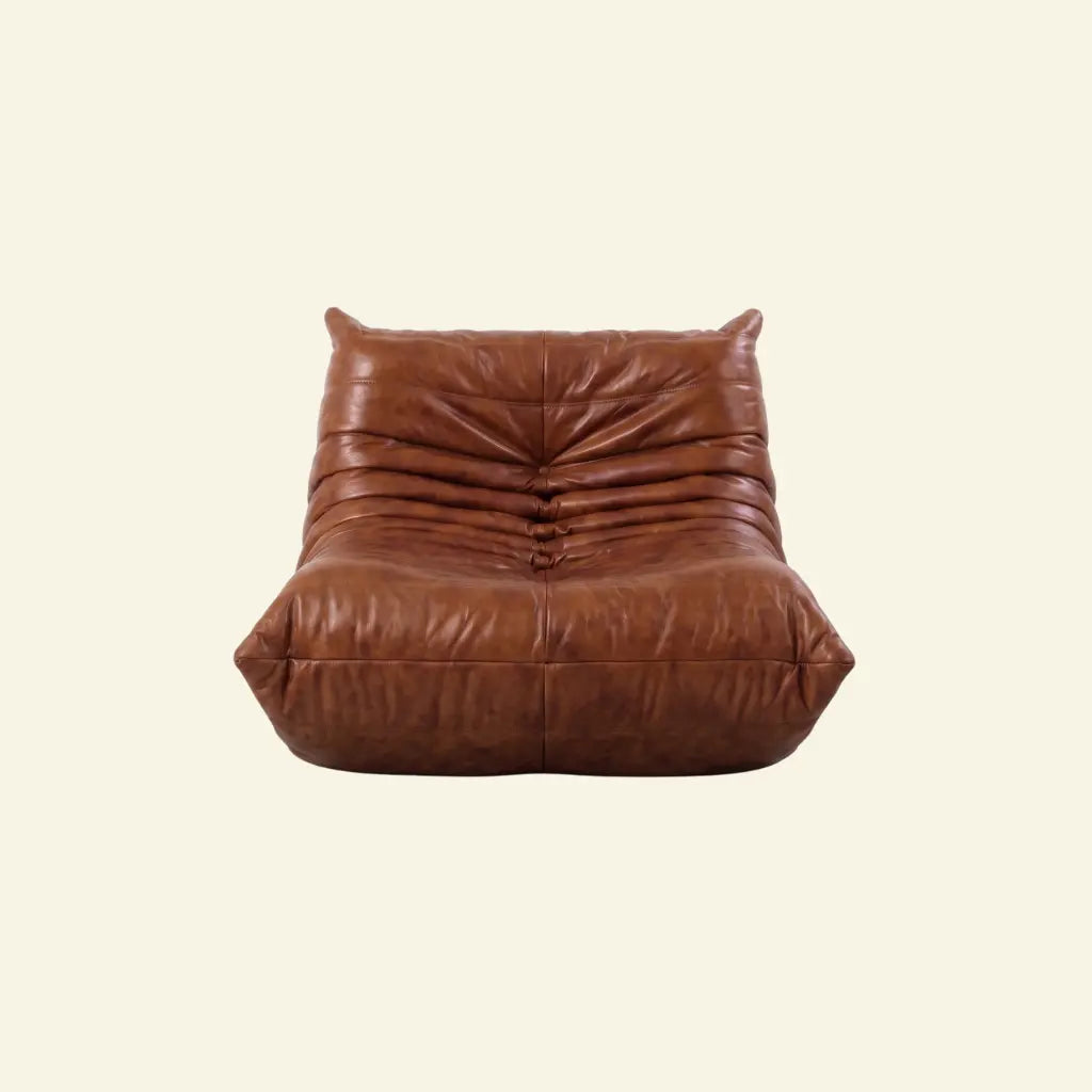 Togo Chair Dupe in brown real oil wax leather on a beige background by vibehaus