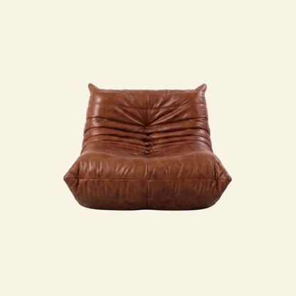 Togo Chair Dupe in brown real oil wax leather on a beige background by vibehaus