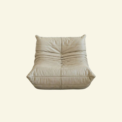 Togo Chair Dupe in cream real cowhide leather on a beige background by vibehaus