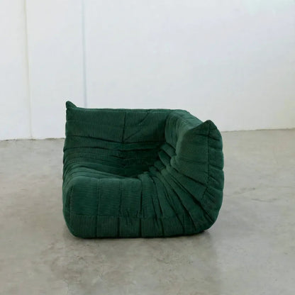 Togo Sofa Corner Dupe in dark green corduroy photographed from the front angle.