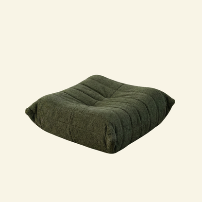 Togo Ottoman Dupe in green bouclé on beige background