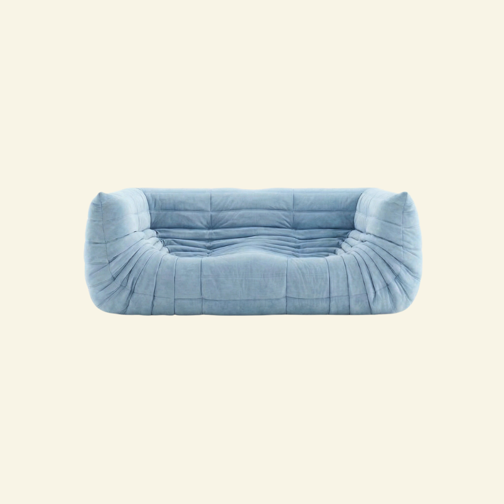 Togo Sofa Dupe in blue with armrests on a beige background