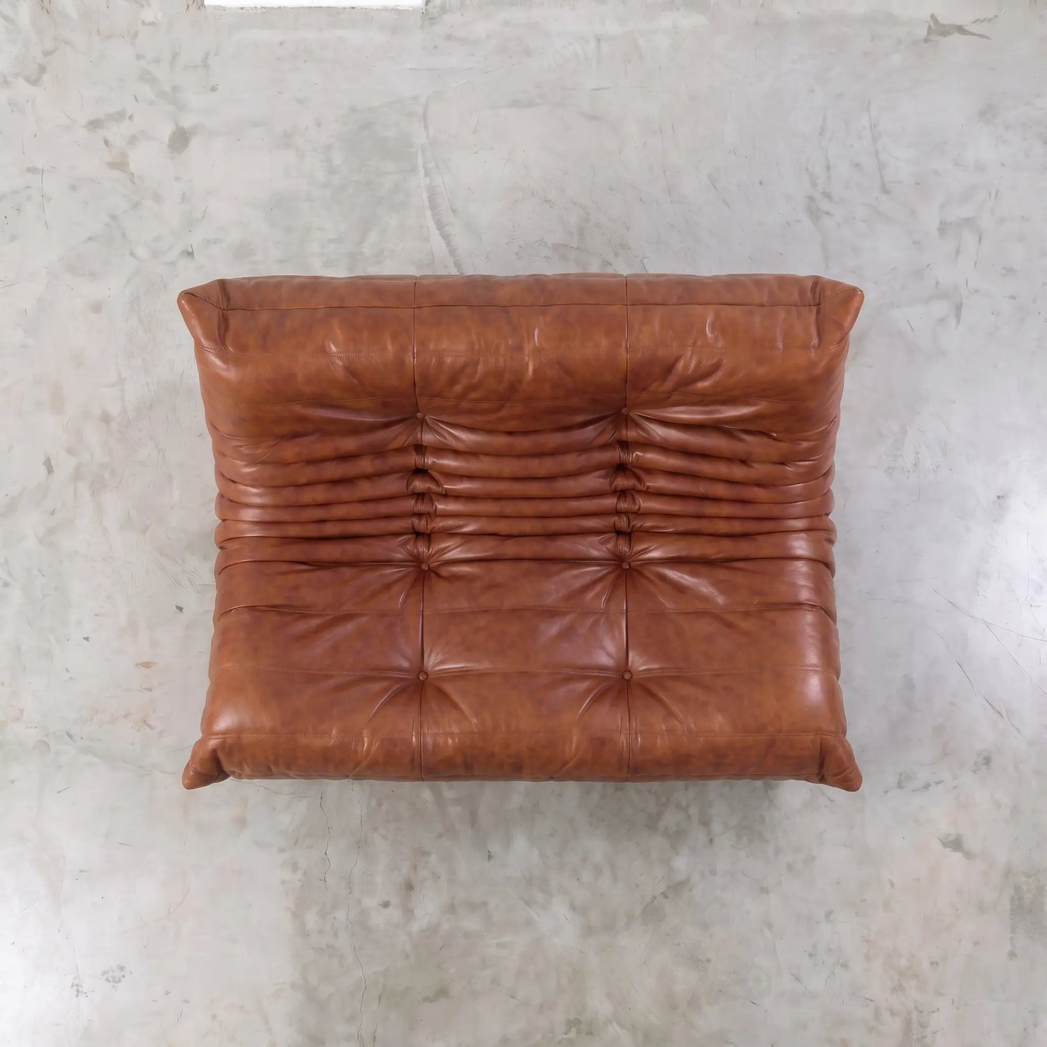 Brown togo sofa dupe in leather in a studio setting