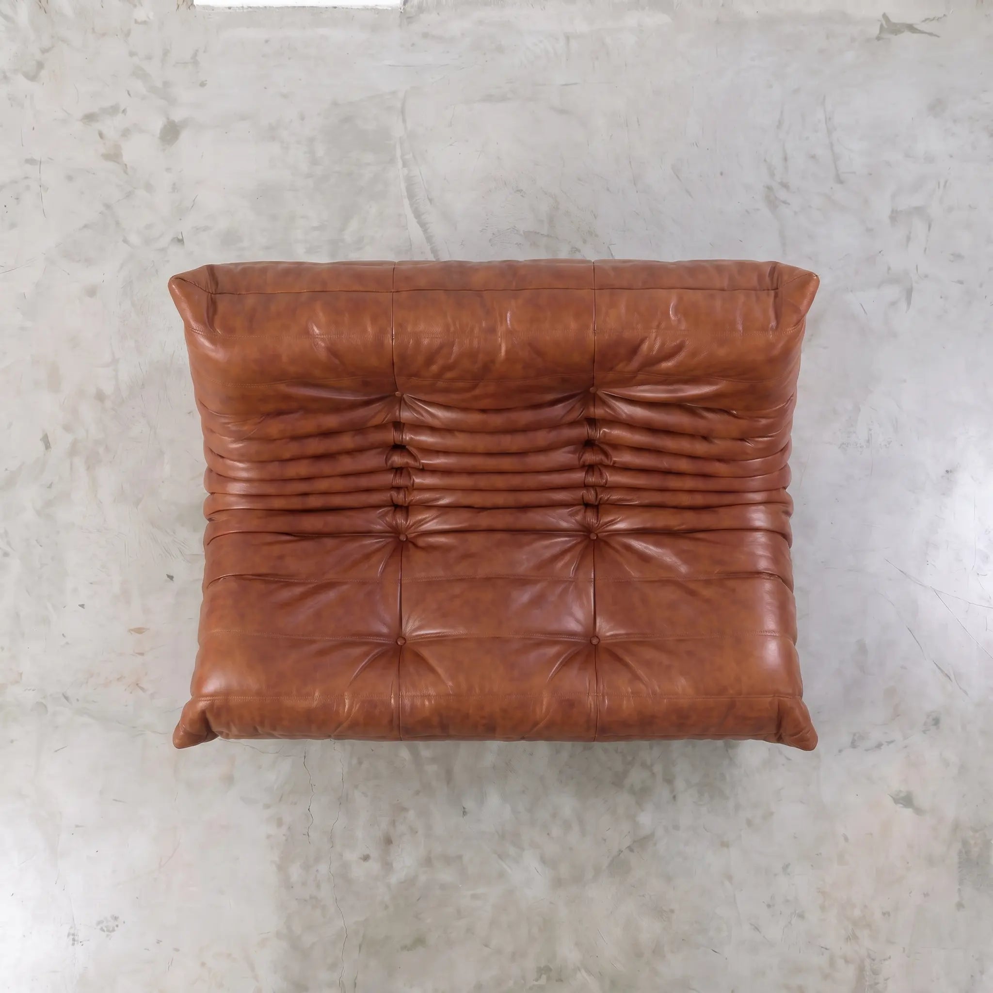 Brown togo sofa dupe in leather in a studio setting