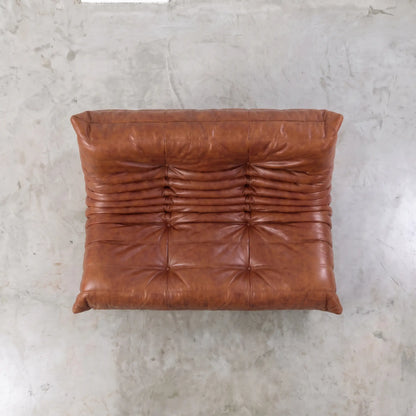 Brown togo sofa dupe in leather in a studio setting