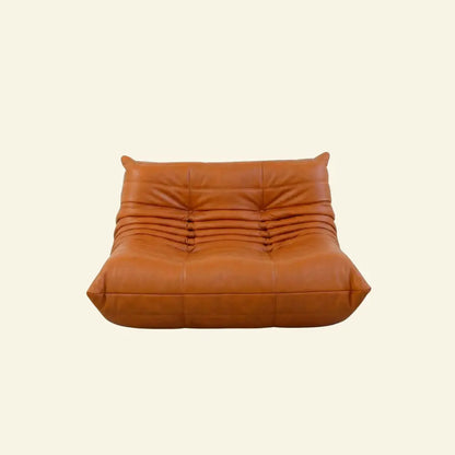 Orange Cognac togo sofa dupe in leather on a light beige background
