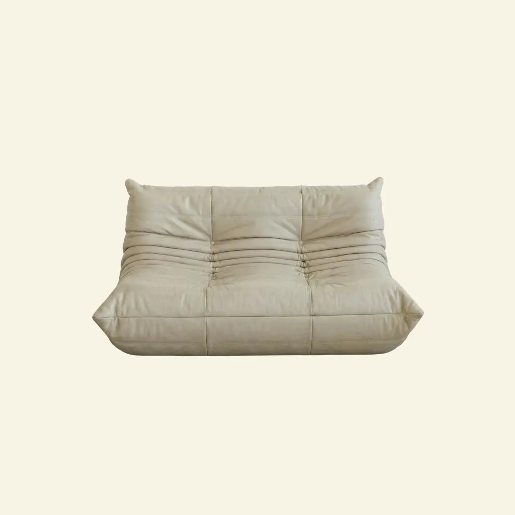 Cream togo sofa dupe in leather on a light beige background