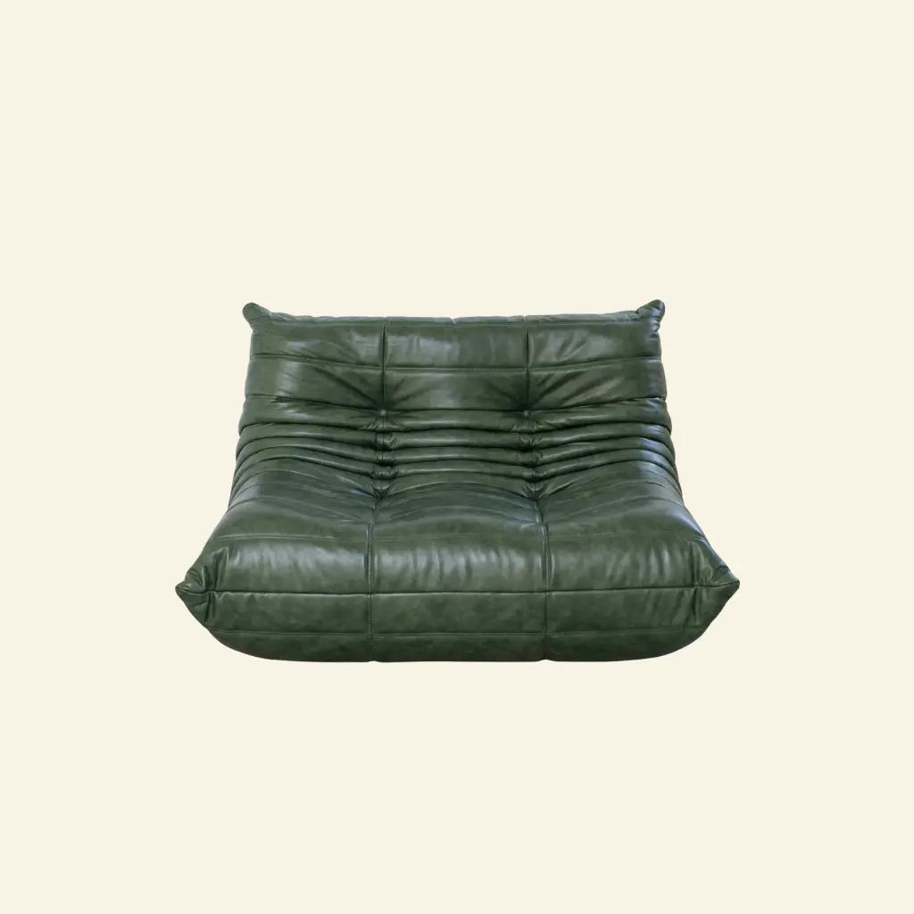 Green togo sofa dupe in leather on a light beige background