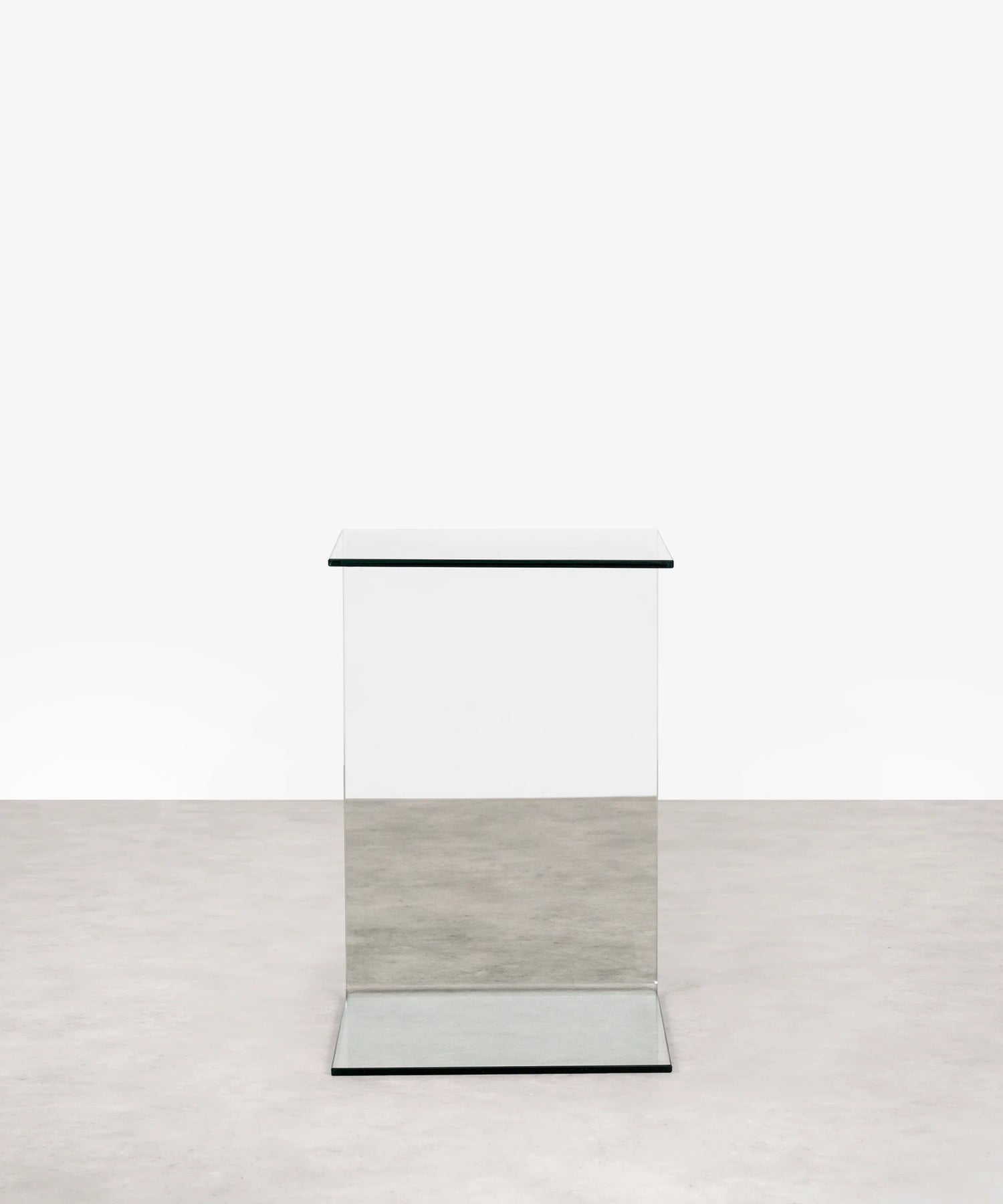 Modern transparent c-shaped side table on a white background