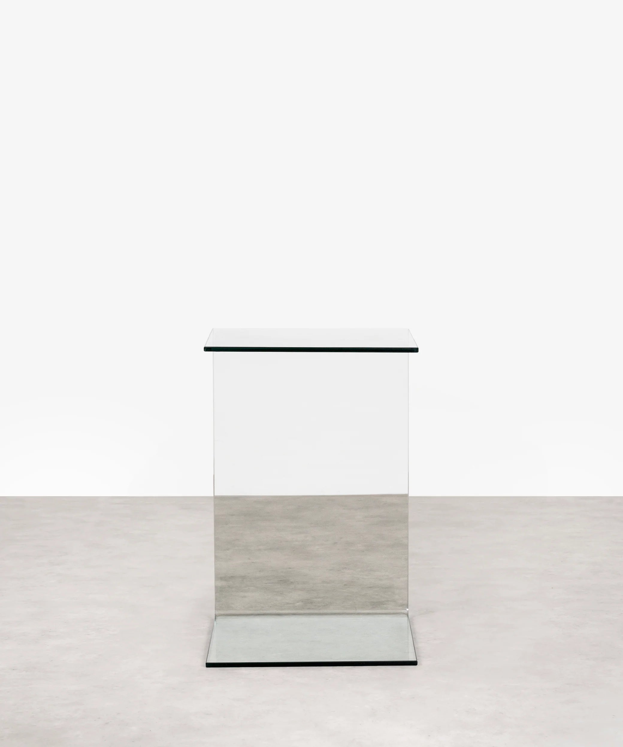 Modern transparent c-shaped side table on a white background
