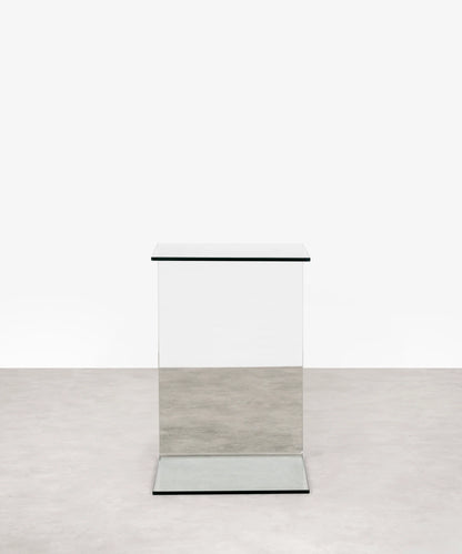 Modern transparent c-shaped side table on a white background
