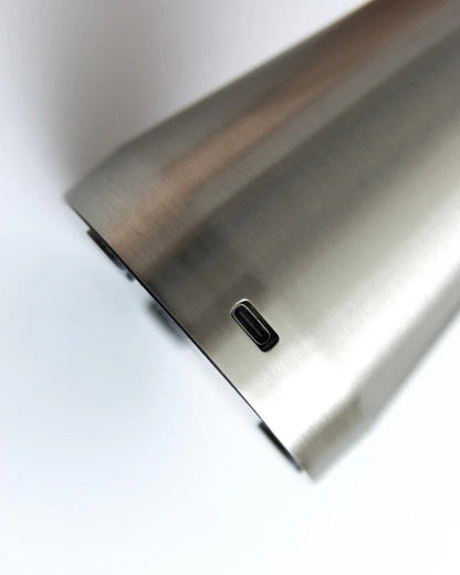 Close-up of a metallic surface of the velo chrome mushroom metal table lamp with a USB-C port on a white background