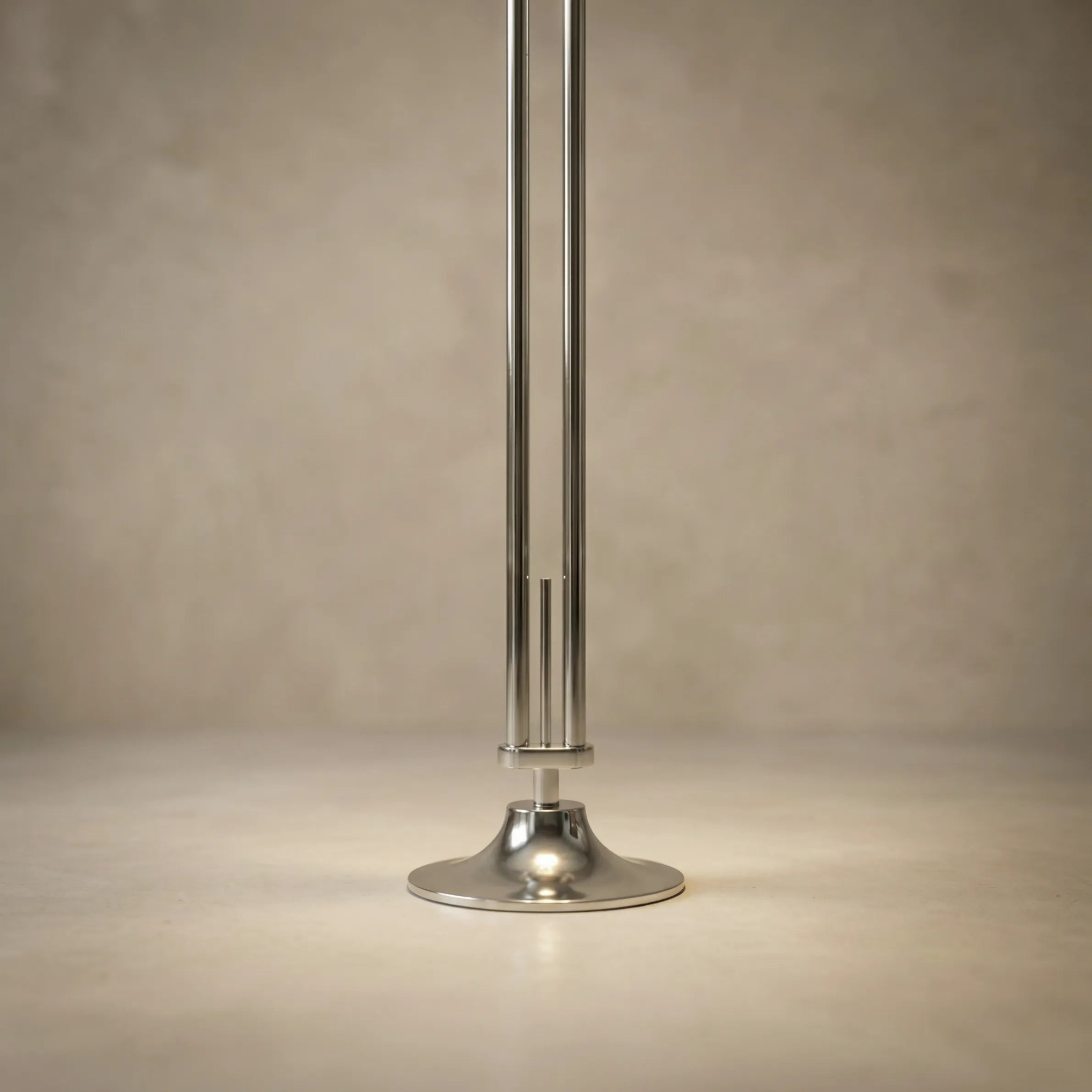 zuru floor to ceiling lamp close-up of chrome pole and round base on neutral background